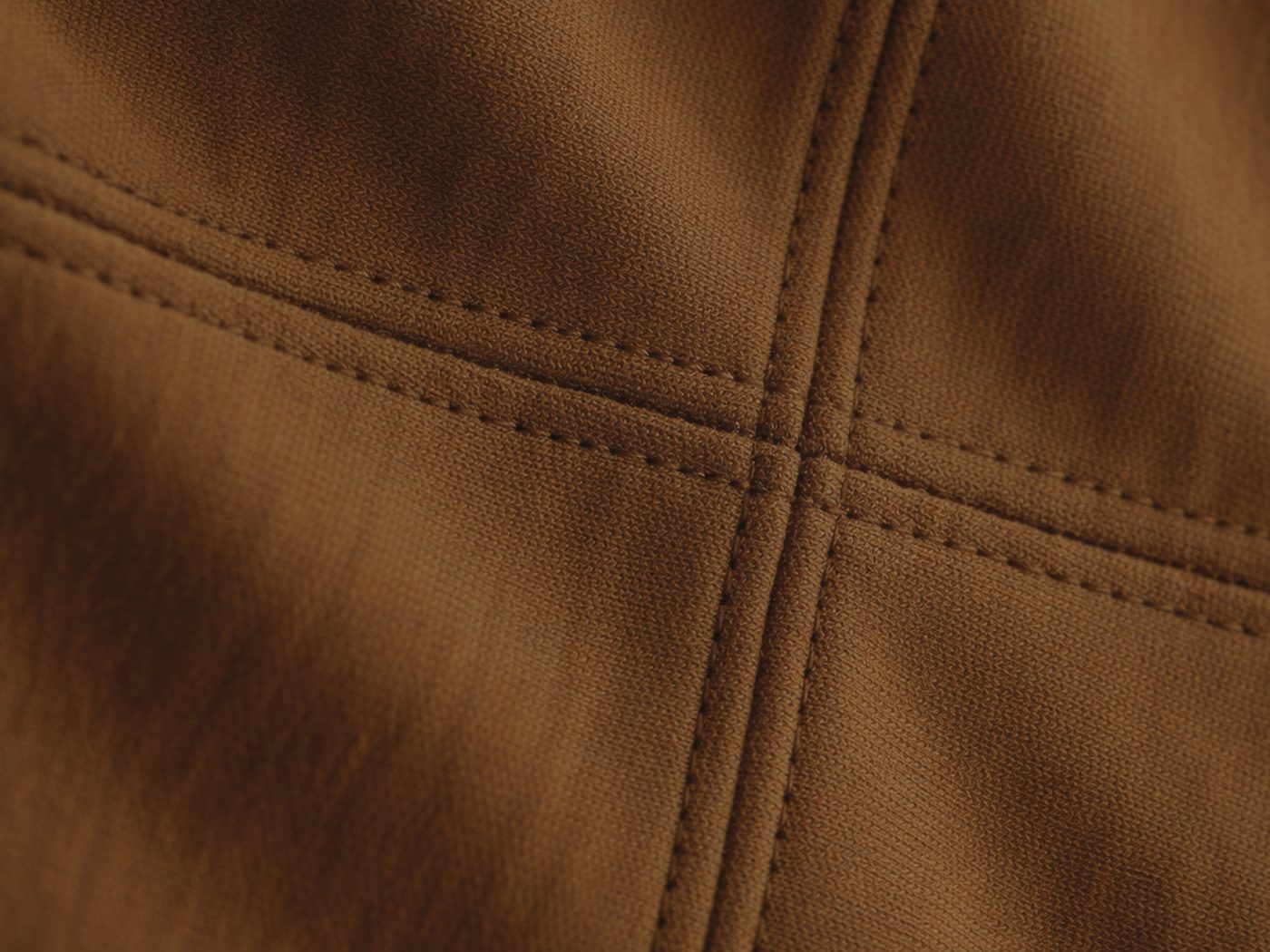 Close-up of the brown T-shirt's cross-seam, stitched along the same grid.